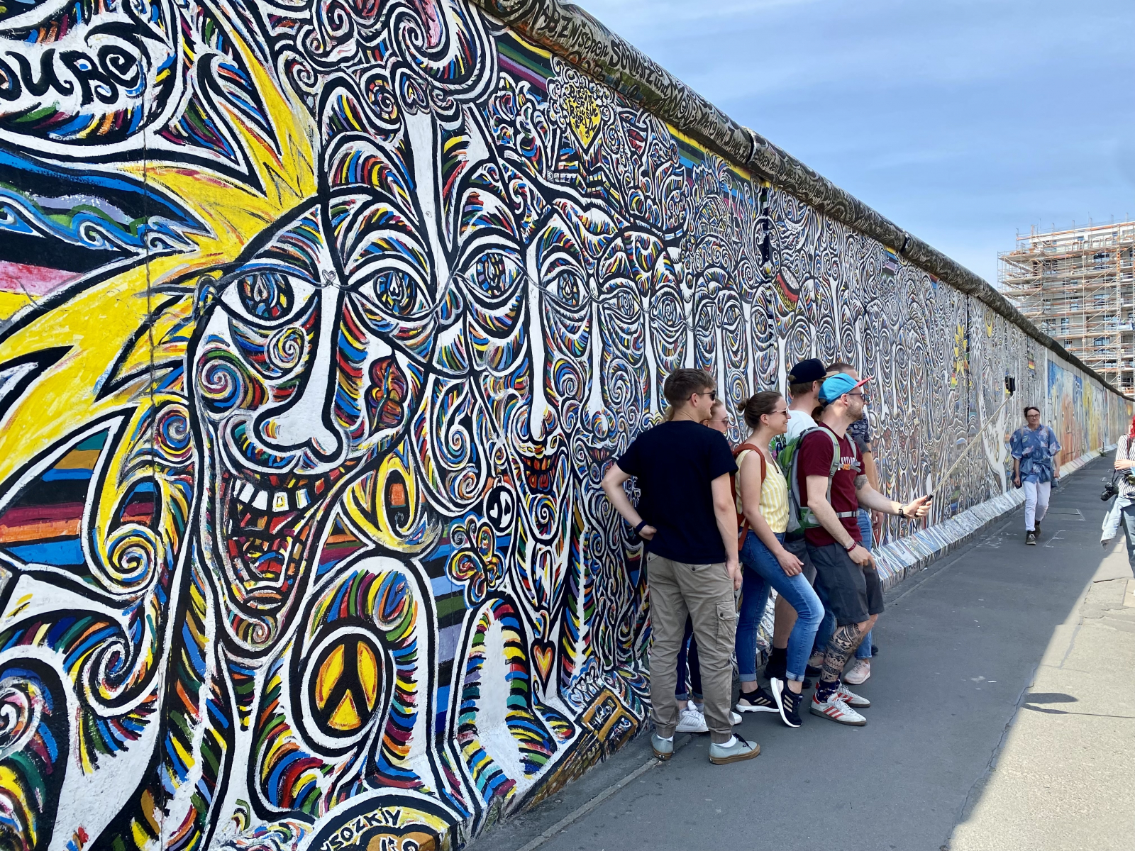 Visitors in front of a mural at the East Side Gallery